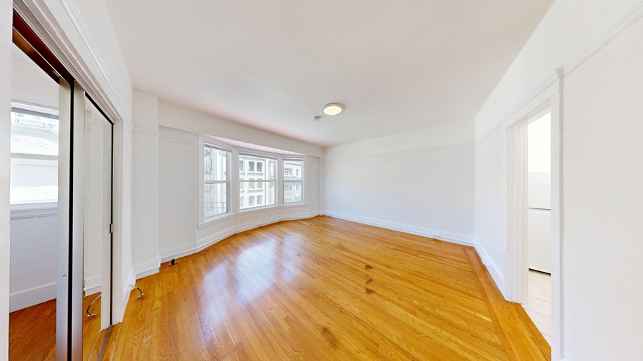 A room with wooden floors and white walls.